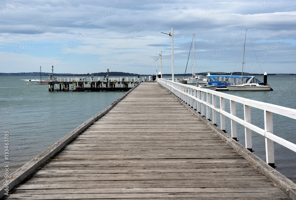Rhyll, Australia - December 29, 2016. Old wood bridge pier at Rhyll (Philip Island, Victoria, Australia). Old wooden jetty with natural background.