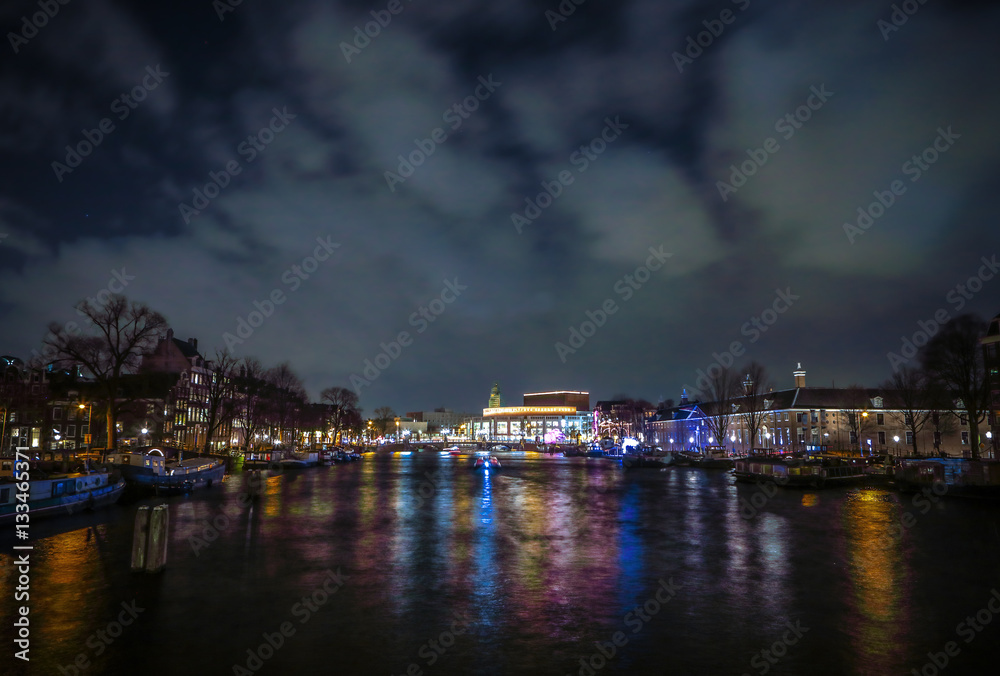 Obraz premium AMSTERDAM, NETHERLANDS - JANUARY 12, 2017: Beautiful night city canals of Amsterdam. January 12, 2017 in Amsterdam - Netherland.