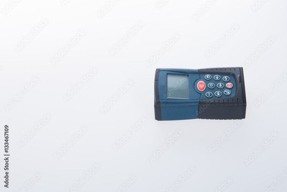 Architectural tool or laser rangefinder on a background.