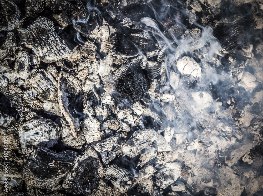 Smoldering embers and fuming close up as a the background. Smoldering embers and fuming close up as a the background.