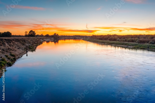 Landscape with river and sky after sunset in the evening