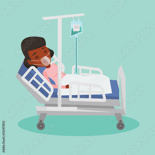 Patient lying in hospital bed with oxygen mask.