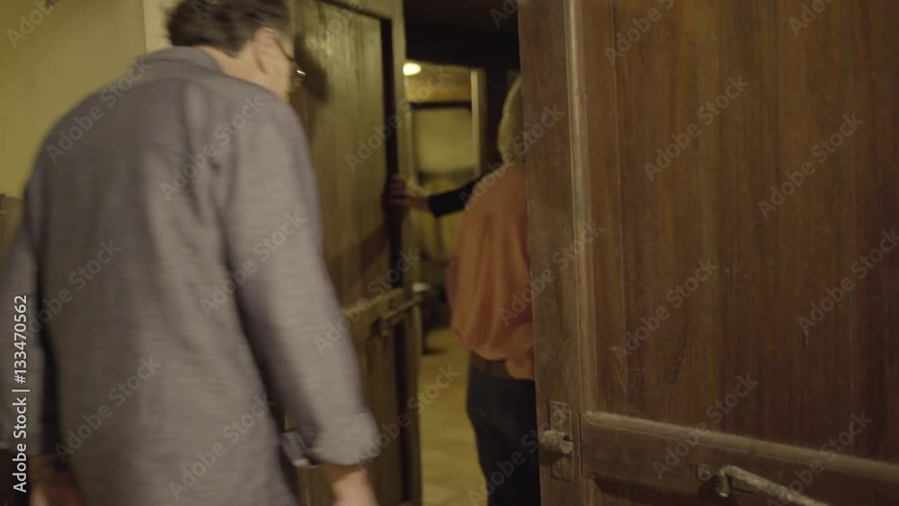 Senior couple entering a wine cellar Senior couple entering a wine cellar