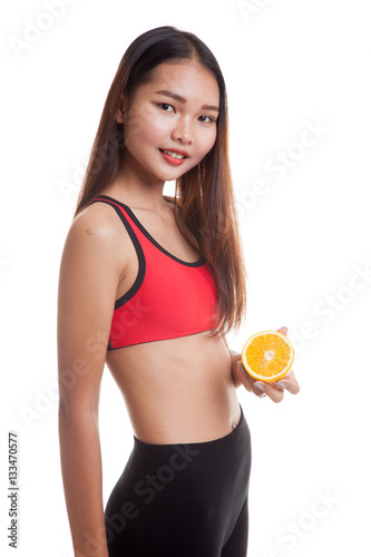 Beautiful Asian healthy girl with orange fruit. © halfbottle