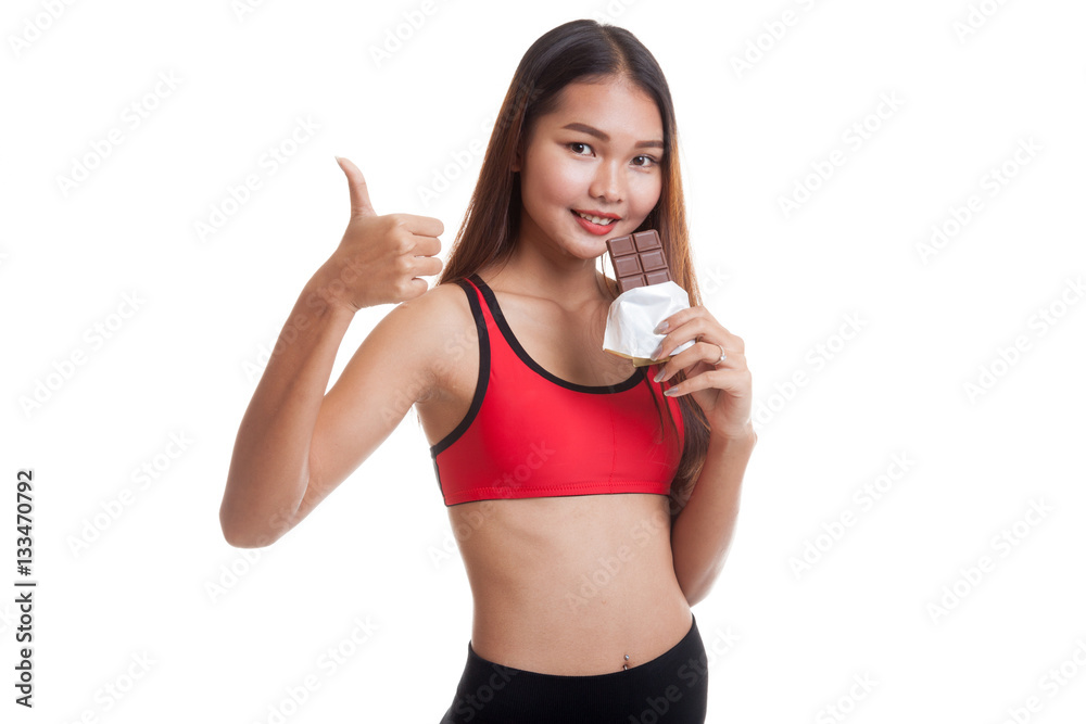 Beautiful healthy Asian girl thumbs up with chocolate. Beautiful healthy Asian girl thumbs up with chocolate.