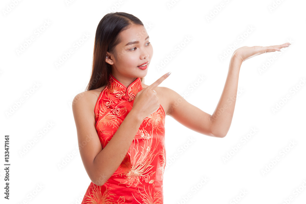 Asian girl in chinese cheongsam dress point to blank space on h Asian girl in chinese cheongsam dress point to blank space on h
