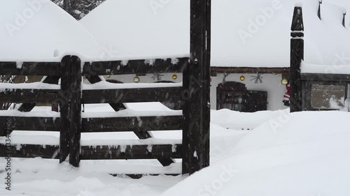 Winter. It is snowing. Snowy old Ukrainian hut with a wooden gate, in which lived famous Ukrainian writer Ivan Kotlyarevsky photo