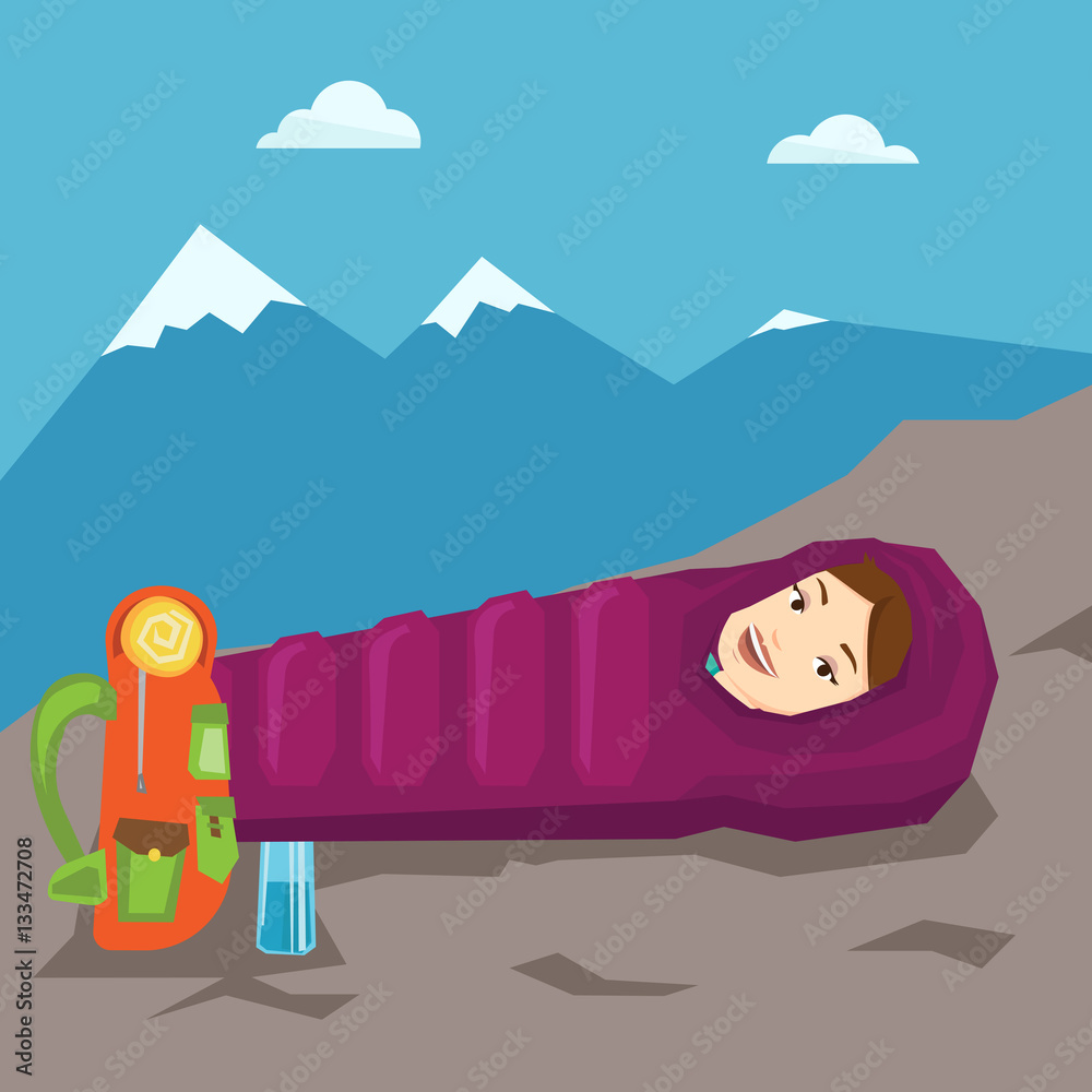 Woman resting in sleeping bag in the mountains.