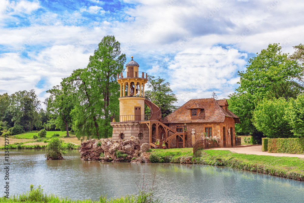 VERSAILLES, FRANCE - JULY 02, 2016 :Lighthouse on the lake in h VERSAILLES, FRANCE - JULY 02, 2016 :Lighthouse on the lake in h