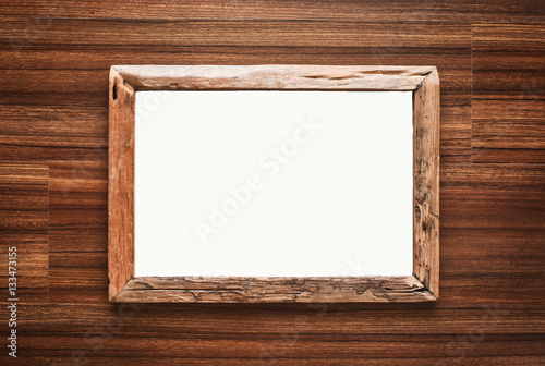 Rustic handmade wooden picture frame on wood background. White space for text.