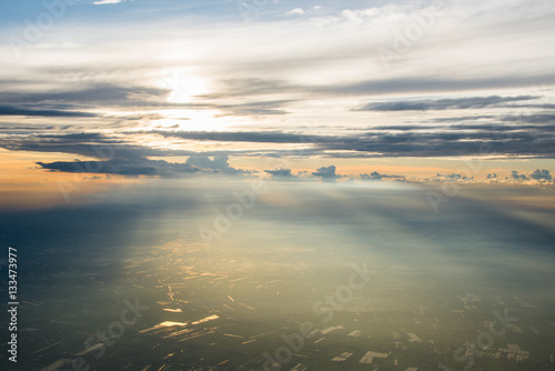Beautiful air view to the  sunset sky over the agricultural land © pongpinun