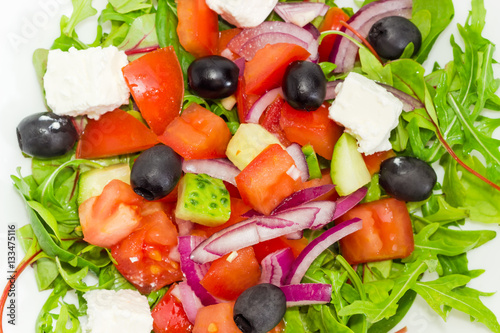 Greek salad in a white dish closeup