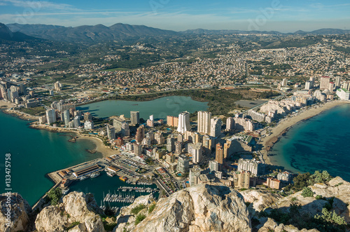 View over Calpe (Calp) town, Spain. Shot from the Penon  ( Ifach) rock, overlooking the coast, the harbor, lake and the city