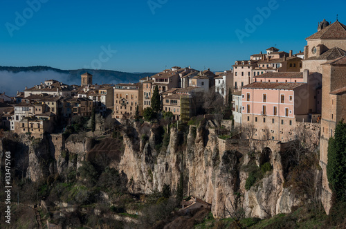 View to hanging houses "casas colgadas" of Cuenca old town.Example of a medieval city, built on the steep sides of a mountain. Many casas colgadas are built right up to the cliff edge. Cuenca, Spain