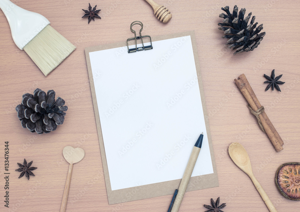 Blank notepad with pine cones on wooden table background Blank notepad with pine cones on wooden table background