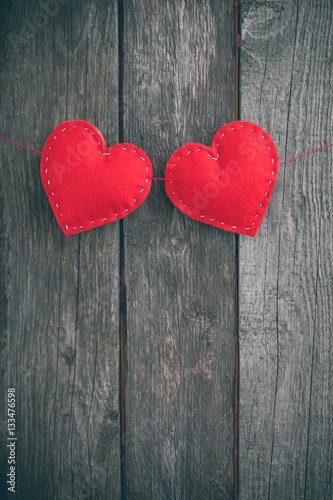 Valentine s day card. Red felt heart placed on vintage wood background and space for your text.
