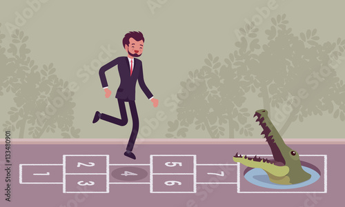 Young carefree businessman playing hopscotch, crocodile in front photo