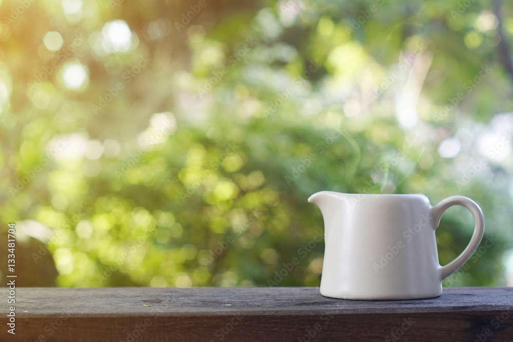 Teapot on wooden table.