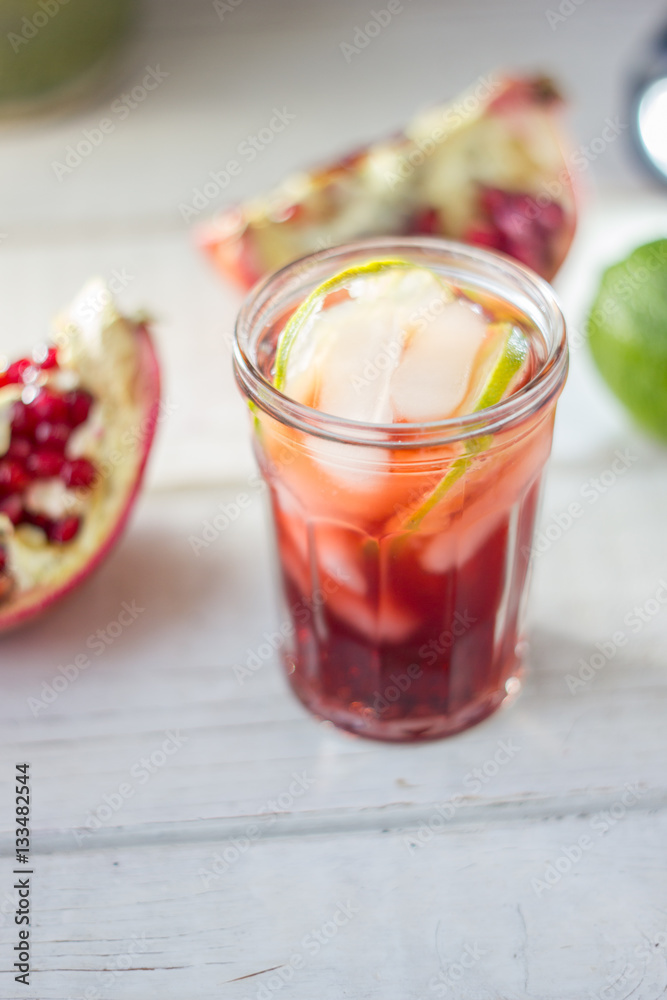Fresh pomegranate drink - lemonade or cocktail with lime and ice Fresh pomegranate drink - lemonade or cocktail with lime and ice