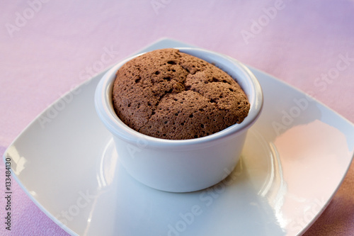 chocolate soufflé on white plate and pink tablecloth