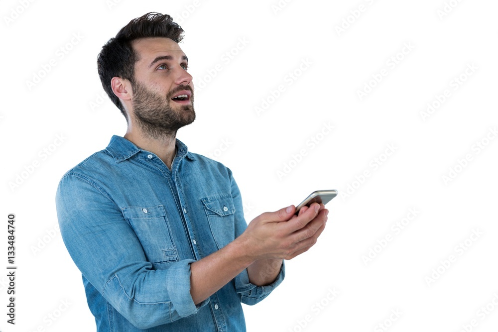 Man dreaming while holding a mobile phone Man dreaming while holding a mobile phone