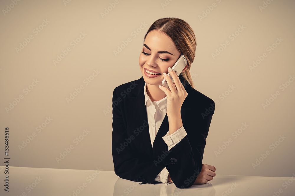 attractive dark-haired woman dressed in a black suit is sitting attractive dark-haired woman dressed in a black suit is sitting