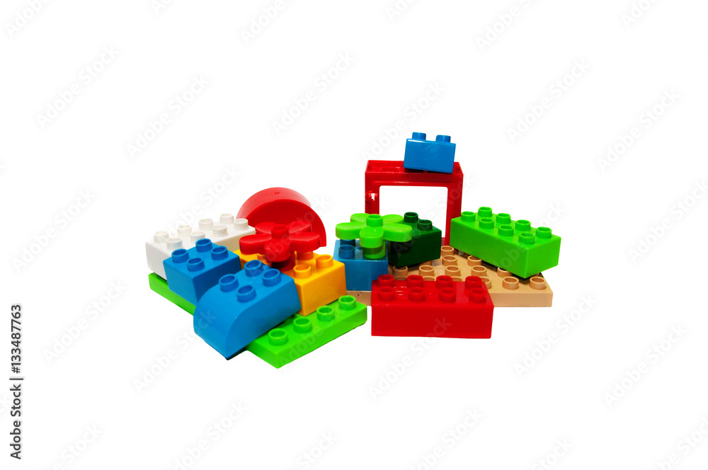 Obraz premium Colorful plastic building bricks on a white background, place fo