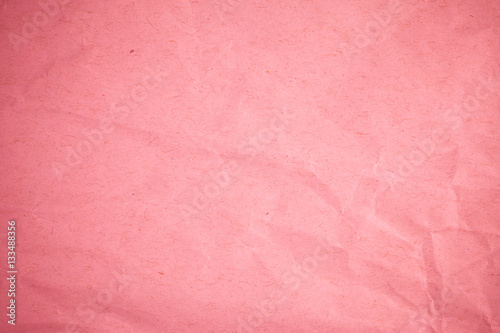Crumpled recycle pink paper background.