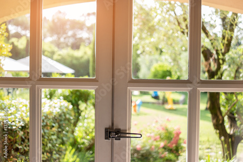 Nature in window. Frames and glass panels. Spend summer in countryside house.