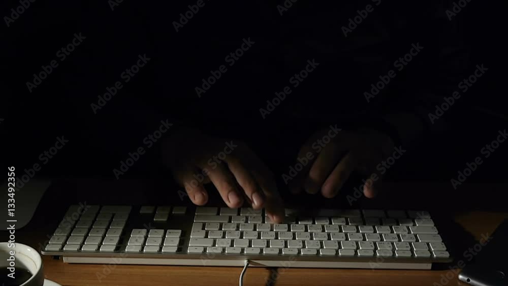 Man at work at the computer enters text using the keyboard Man at work at the computer enters text using the keyboard