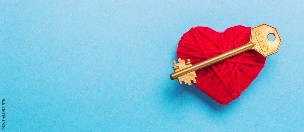 Golden Key to a red heart on a blue background. Love Valentine's Day