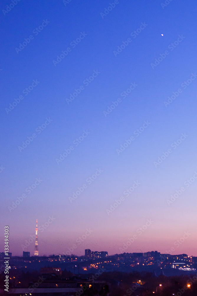 Chisinau city in the evening with a purple sunset, view on tv station moon, moldova, vertical shot
