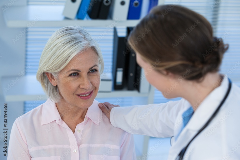 Close-up of female doctor consoling a patient Close-up of female doctor consoling a patient