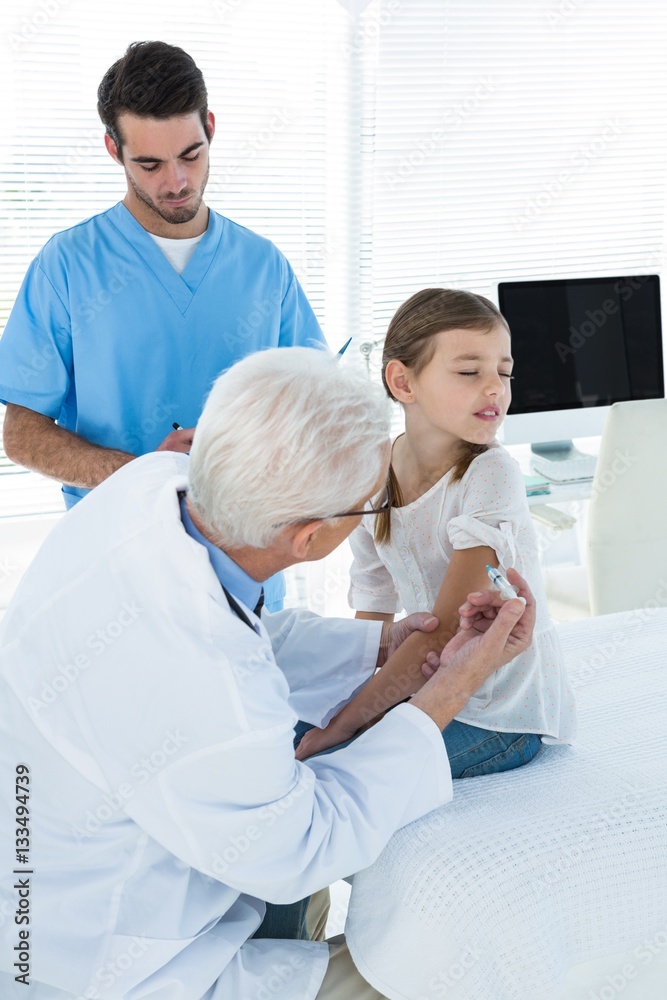 Doctor giving an injection to the patient Doctor giving an injection to the patient