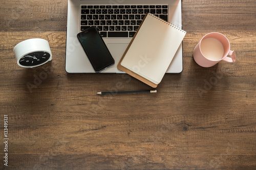 Working place, Laptop, Memo, Clock, Coffee cup on wooden background.