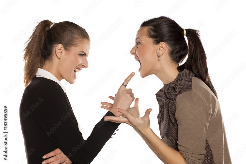 Two young angry woman yelling at each other Two young angry woman yelling at each other