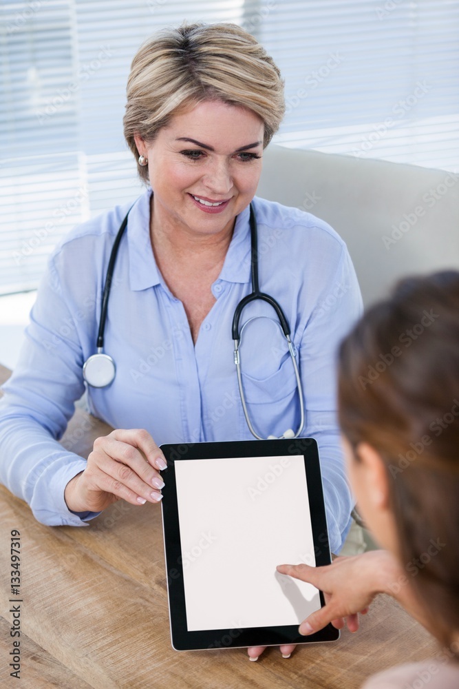 Doctor showing digital tablet to patient Doctor showing digital tablet to patient