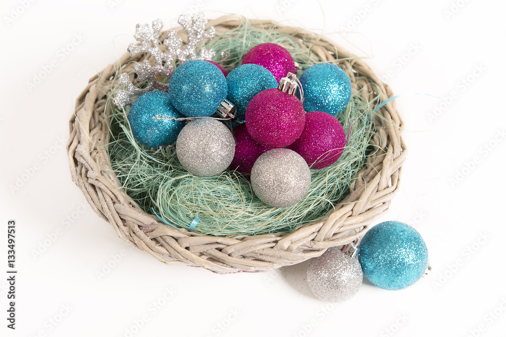 Christmas balls lying in a basket in the nest