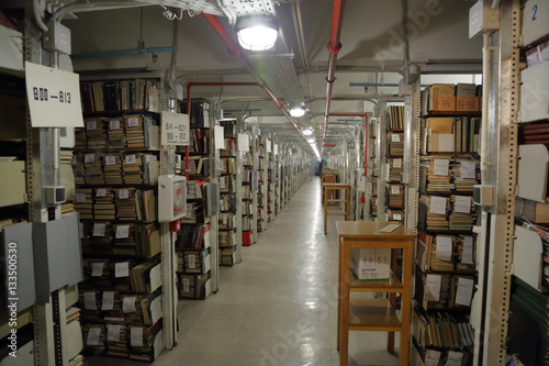 Long corridor with iron shelves with books