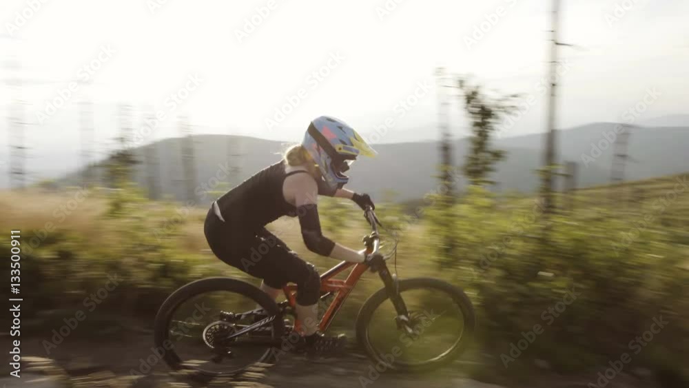 Woman riding MTB mountain bike single line in Mountains Woman riding MTB mountain bike single line in Mountains