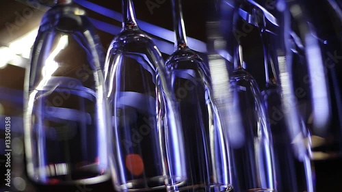 wine glasses hanging above the bar at a nightclub photo