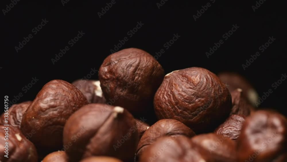 SLOW MOTION: Macro shot of falling of hazelnutes on a heap SLOW MOTION: Macro shot of falling of hazelnutes on a heap