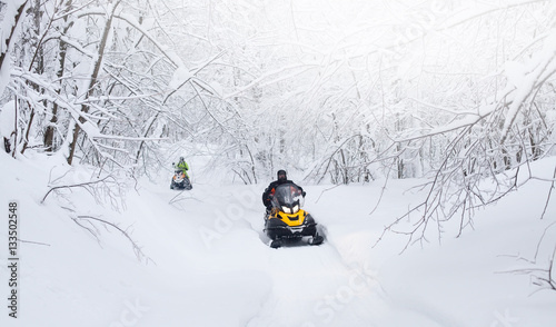 Winter Finnish snowy lanscape with road and snowmobile