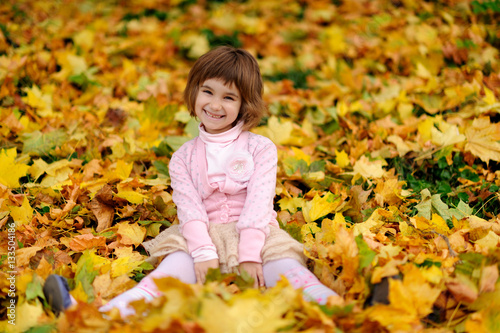 happy little child  laughing and playing in the autumn
