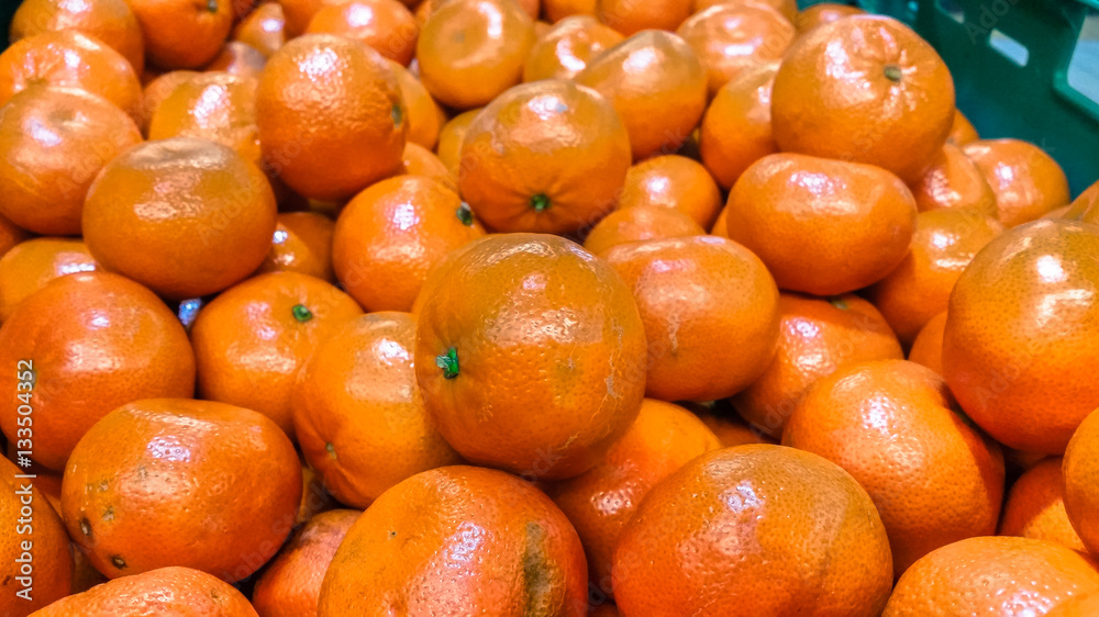 Group of fresh organic mandarins in a marketplace Group of fresh organic mandarins in a marketplace