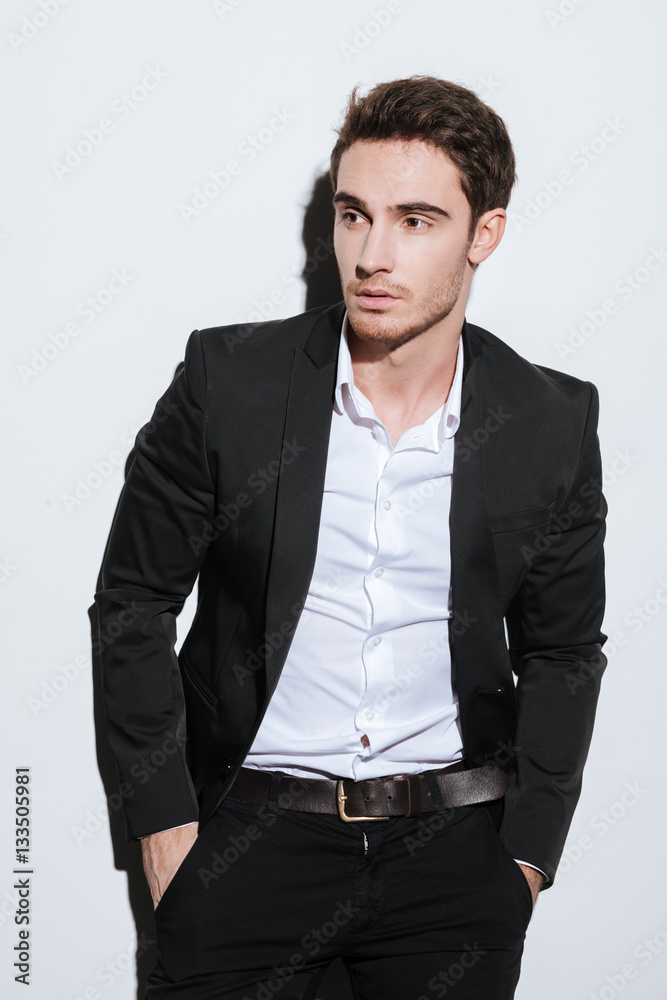 Fototapeta premium Serious businessman standing at studio