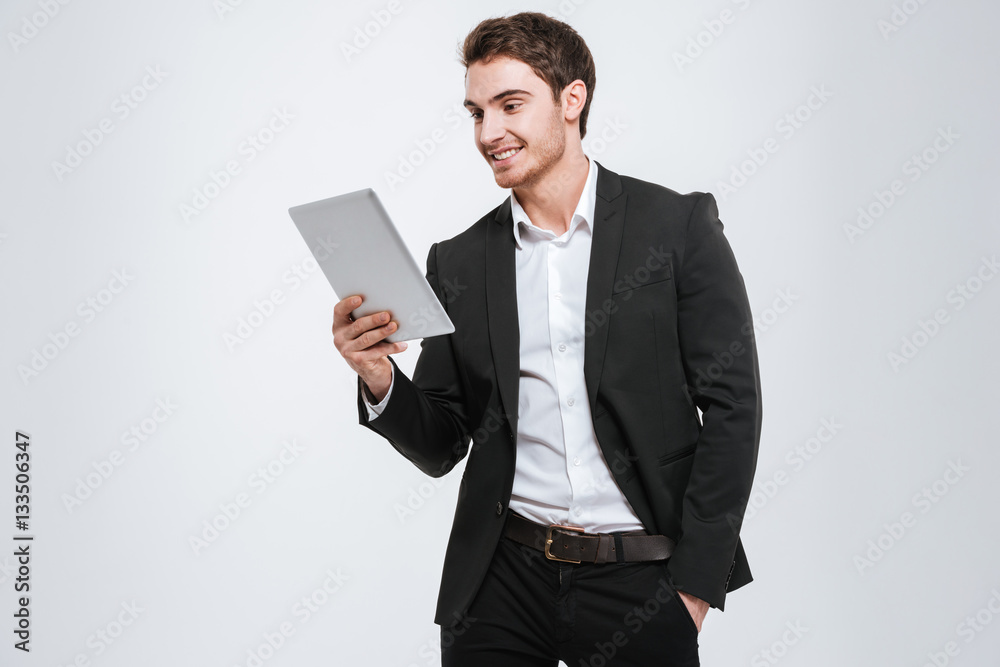 Young caucasian businessman holding tablet computer Young caucasian businessman holding tablet computer