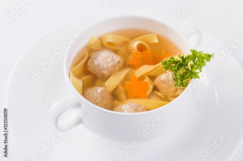 chicken broth on a light background (close top view)