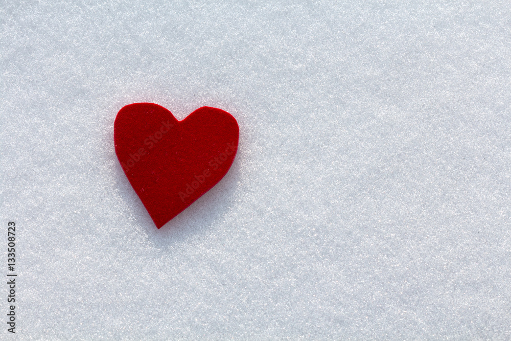 Obraz premium Cutout red heart in the snow