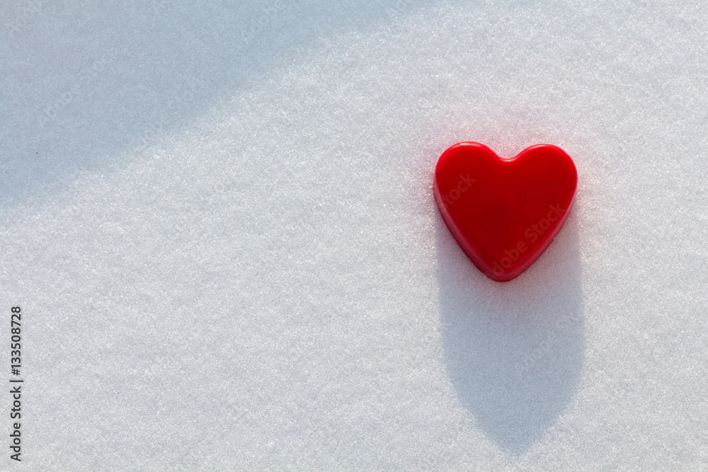 Red heart in the snow with sunshine Red heart in the snow with sunshine